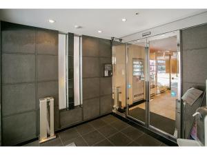 a bathroom with glass doors and a walk in shower at Mars Garden Hotel Hakata - Vacation STAY 48738v in Fukuoka