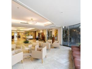 a lobby with a waiting room with couches and chairs at Mars Garden Hotel Hakata - Vacation STAY 48738v in Fukuoka