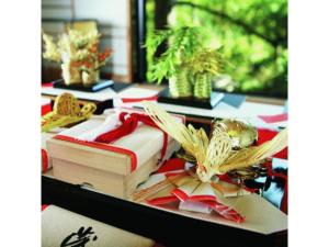 a table with three books and bows on it at Dogo Onsen Funaya - Vacation STAY 54201v in Matsuyama +30 photos