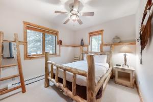 a bedroom with a wooden bed and a ceiling fan at Waterstone 2748 in Steamboat Springs +77 photos