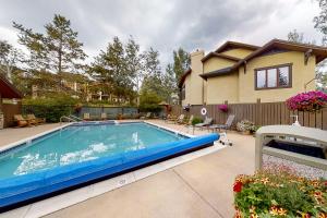 a swimming pool in front of a house at Waterstone 2748 in Steamboat Springs