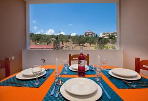 a dining room table with a bottle of wine on it at Drimouras Apartments in Xiropigado