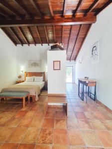 a bedroom with a bed and a table at Monte do Brejinho de Água in Carvalhal