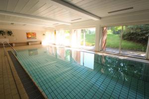 a large swimming pool in a house at Sauntehus Castle Hotel in Hornbæk