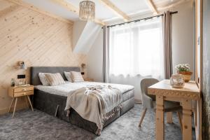 sypialnia z łóżkiem, biurkiem i oknem w obiekcie Folkova 21 - Apartamenty w Białym Dunajcu