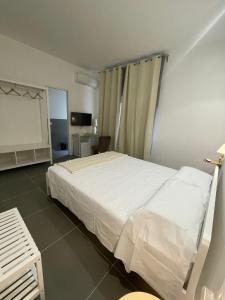 Un dormitorio con una gran cama blanca en una habitación. en Milu's Home, en Palermo 11 fotos más