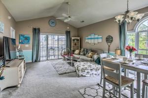 a living room with a couch and a table at Lovely Myrtle Beach Condo 4 Mi to Boardwalk! in Myrtle Beach