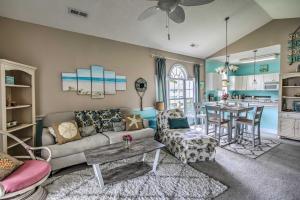 a living room with a couch and a table at Lovely Myrtle Beach Condo 4 Mi to Boardwalk! in Myrtle Beach