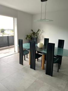 a dining room with a glass table and chairs at Modern Living in Riazzino