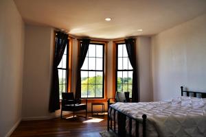 a bedroom with a bed and a large window at Gorge View in Niagara Falls