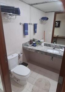 a bathroom with a toilet and a sink at Lindo Flat Aconchegante no Centro de Taguatinga in Taguatinga