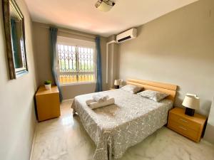 a bedroom with a bed and a window at Riviera Golf apartment in Mijas Costa