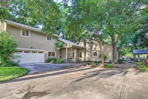 a house with a driveway and a garage at Guadalupe River Paradise with Hot Tub, Dock and Kayaks in Seguin