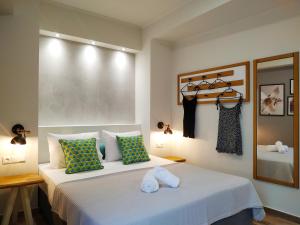 a bedroom with a bed with two towels on it at SUNNY DAYS in Limenaria