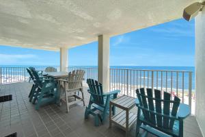a porch with chairs and a table on the beach at Windward Pointe Unit 901 in Orange Beach