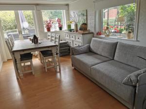 a living room with a couch and a table at Trummenäs Golf/Bad/Restaurang in Ramdala