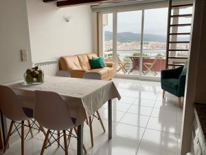 a living room with a table and a couch at Pérola de Viana - Cabedelo in Viana do Castelo