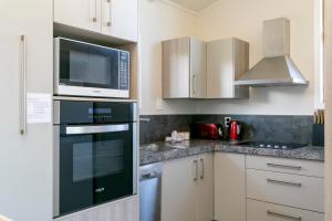 a kitchen with a microwave and a stove top oven at Mercy of Lake Taupo in Taupo