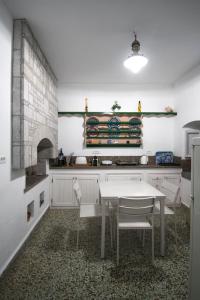 a kitchen with a table and chairs in it at Villa Sylvia in Symi
