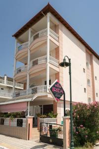 a building with a sign in front of it at Villa Irida Sun in Olympic Beach