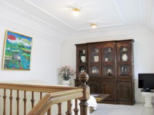 a living room with a wooden cabinet and a tv at Apartment Storchenfärbe in Memmingen +28 photos