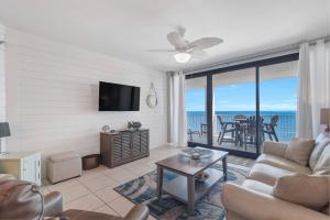 a living room with a view of the ocean at Windward Point Unit 1004 in Orange Beach