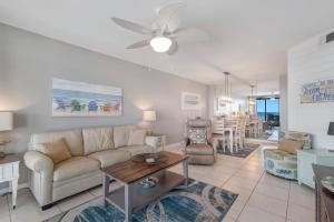 a living room with a couch and a table at Windward Point Unit 1004 in Orange Beach