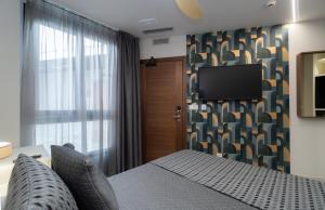 Телевизор и/или развлекательный центр в Hotel Perla del Sur