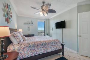 a bedroom with a bed and a ceiling fan at Windward Point Unit 1004 in Orange Beach +37 photos