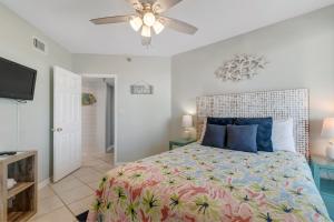 a bedroom with a bed and a ceiling fan at Windward Point Unit 1004 in Orange Beach