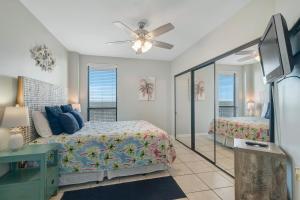 a bedroom with two beds and a ceiling fan at Windward Point Unit 1004 in Orange Beach