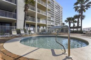 a swimming pool in front of a apartment building at Windward Point Unit 1004 in Orange Beach