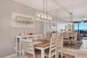 a dining room with a table and chairs at Windward Point Unit 1004 in Orange Beach