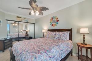 a bedroom with a bed and a ceiling fan at Windward Point Unit 1004 in Orange Beach