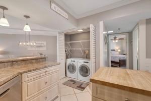a laundry room with a washer and dryer at Windward Point Unit 1004 in Orange Beach