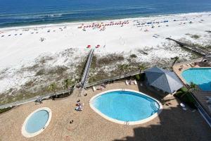 an overhead view of a beach with two swimming pools at Windward Point Unit 1004 in Orange Beach