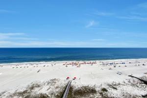 a beach with a lot of people and the ocean at Windward Point Unit 1004 in Orange Beach