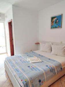 ein Bett mit einer blau-weißen Bettdecke darauf in der Unterkunft Apartments and Rooms Marica in Makarska