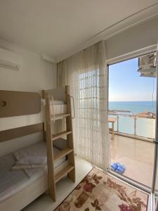 a bedroom with a bunk bed and a view of the ocean at sunset villa in Cimenli