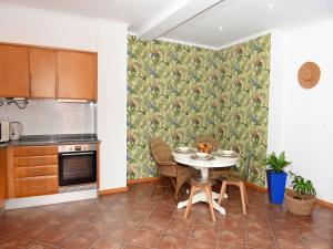 a kitchen with a table and chairs in a room at Flamingo Apartment in Furnas