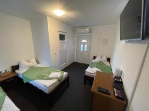 a hotel room with two beds and a desk at 451 Rooms in Graz