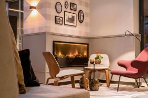 a living room filled with furniture and a fire place at Best Western Premier Alsterkrug Hotel in Hamburg