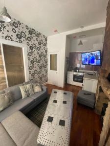 a living room with a couch and a table at Glasgow City Centre Apartment in Glasgow +23 photos