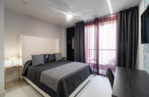 Кровать или кровати в номере Hotel Perla del Sur