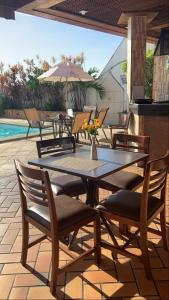 a table and chairs with a vase of flowers on a patio at Flat 308 Vista Mar in Salvador