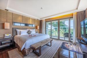 Voodi või voodid majutusasutuse Shenzhen Dameisha Kingkey Palace Hotel toas