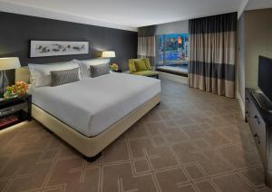 a bedroom with a large bed and a television at Crown Towers Melbourne in Melbourne