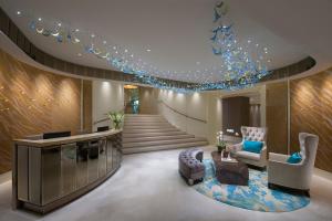 a lobby of a hotel with a staircase with blue lights at Crown Towers Melbourne in Melbourne
