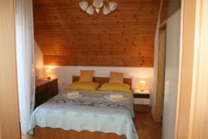 a bedroom with a bed with two yellow pillows at Adriana Guesthouse in Jezerce