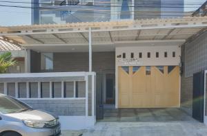a car parked in front of a building with a garage at RedDoorz near Istana Plaza 3 in Bandung